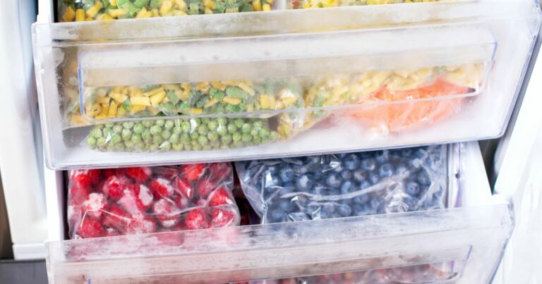 Plastic bags with different frozen vegetables in refrigerator. Vegetables on the freezer shelves.